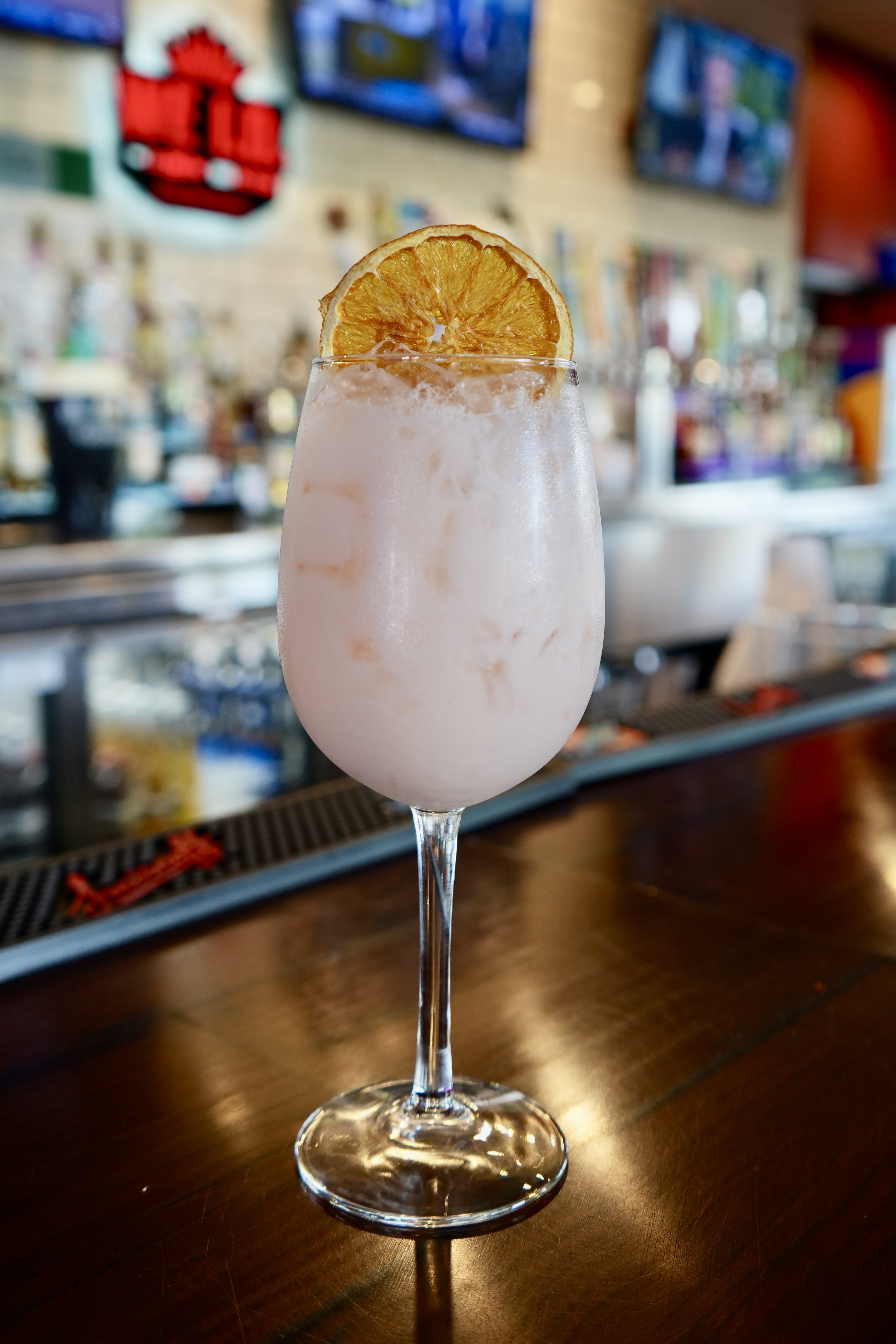 Frozen cocktail with a dried orange wheel