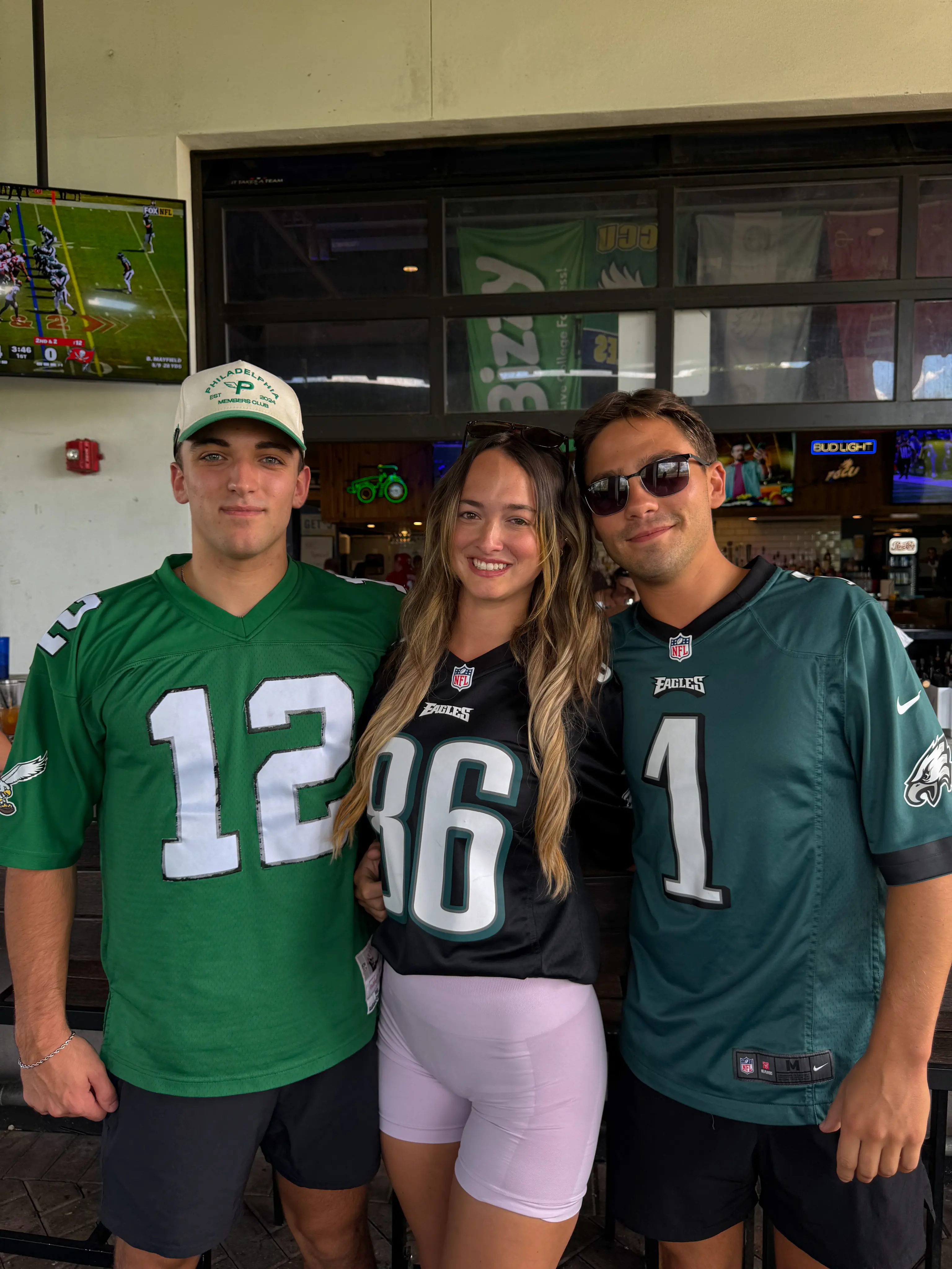 Game-day crowd in jerseys at the outdoor bar